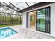 View of the pool area and outdoor access to the main bedroom with screened-in lanai at 25583 Prada Dr, Punta Gorda, FL 33955