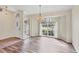 Inviting dining area features an arched window, pendant lighting, and wood-look floors at 2700 Colonade Ln, North Port, FL 34286