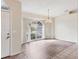 Elegant dining area featuring an arched window, tiled floors, and a chandelier at 2700 Colonade Ln, North Port, FL 34286