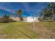 Expansive backyard with lush grass and a white clothesline, perfect for outdoor activities and relaxation at 3210 Holly Ave, Englewood, FL 34224