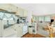 Cozy kitchen featuring vintage appliances and charming decor, adjacent to a comfortable living space at 3210 Holly Ave, Englewood, FL 34224