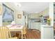 Bright kitchen with an adjacent dining area, showcasing wooden floors and functional cabinetry, perfect for cozy meals at 3210 Holly Ave, Englewood, FL 34224