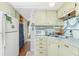 Efficient kitchen with appliances and plenty of storage space that leads into a cozy dining area and living space at 3210 Holly Ave, Englewood, FL 34224