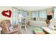 Inviting living room featuring a daybed and comfortable seating, complemented by bright curtains and accents at 3210 Holly Ave, Englewood, FL 34224