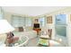 Cozy living space filled with natural light from the large windows and complete with comfortable furnishings at 3210 Holly Ave, Englewood, FL 34224