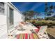 Outdoor patio with lounge chairs and table, surrounded by landscape, offering an inviting space at 3210 Holly Ave, Englewood, FL 34224