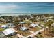 Picturesque aerial shot of waterfront home offering easy access to local shops, restaurants, and coastal activities at 3220 Holly Ave, Englewood, FL 34224