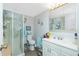 Clean bathroom with a glass shower, white cabinets, and a modern sink at 3220 Holly Ave, Englewood, FL 34224
