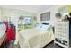 Bright bedroom featuring a large window, wood-look floors, and a standard-size bed at 3220 Holly Ave, Englewood, FL 34224