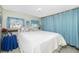 Cozy bedroom featuring a large window, wood-look floors, and a comfortable bed at 3220 Holly Ave, Englewood, FL 34224