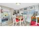 Bright dining area features wood-look floors and a table with four chairs and backyard views at 3220 Holly Ave, Englewood, FL 34224