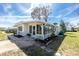 Well-maintained home exterior with an enclosed sunroom, landscaped yard, and a serene setting at 3220 Holly Ave, Englewood, FL 34224