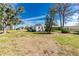 Cozy single-story home featuring a well-maintained lawn and classic siding under a beautiful blue sky at 3220 Holly Ave, Englewood, FL 34224