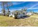 Charming single-story home with a welcoming entrance and neatly landscaped front yard under clear blue skies at 3220 Holly Ave, Englewood, FL 34224