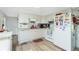 Functional kitchen featuring white cabinetry, laminate countertops, and essential appliances at 3220 Holly Ave, Englewood, FL 34224