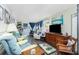 Spacious living room with comfortable seating, wood-look floors, and a view of the office area at 3220 Holly Ave, Englewood, FL 34224