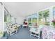 Bright and airy sunroom filled with comfortable seating, perfect for relaxing and entertaining at 3220 Holly Ave, Englewood, FL 34224