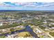 Aerial view of waterfront homes surrounded by lush landscaping and clear blue skies at 4050 Rock Creek Dr, Port Charlotte, FL 33948