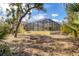 View of backyard with screened in patio, and a fire pit at 4050 Rock Creek Dr, Port Charlotte, FL 33948