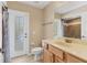 Bathroom features a single sink vanity with shower, door to the outside, and modern fixtures at 4050 Rock Creek Dr, Port Charlotte, FL 33948