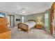 Cozy bedroom with green walls, neutral carpet, ceiling fan and natural light from two windows at 4050 Rock Creek Dr, Port Charlotte, FL 33948