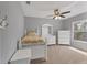Neutral bedroom with neutral carpet, ceiling fan and natural light from a window at 4050 Rock Creek Dr, Port Charlotte, FL 33948