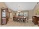 Elegant dining room featuring a chandelier, wood furniture, and natural light through large windows at 4050 Rock Creek Dr, Port Charlotte, FL 33948