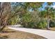 Picturesque driveway surrounded by lush vegetation, leading up to the home at 4050 Rock Creek Dr, Port Charlotte, FL 33948