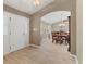 Inviting foyer with light tile flooring, a front door with sidelights, and arched entry to the dining room at 4050 Rock Creek Dr, Port Charlotte, FL 33948