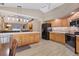Open kitchen with wooden cabinets, stainless steel appliances, and a central island with a bar at 4050 Rock Creek Dr, Port Charlotte, FL 33948
