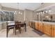 Bright kitchen and dining area overlooking the pool, featuring wooden cabinetry and stainless steel appliances at 4050 Rock Creek Dr, Port Charlotte, FL 33948