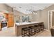 Modern kitchen island with quartz countertop, bar seating, and stylish pendant lighting at 4050 Rock Creek Dr, Port Charlotte, FL 33948