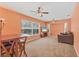 Spacious living room with carpet, ceiling fans, natural light, and views of the pool at 4050 Rock Creek Dr, Port Charlotte, FL 33948