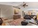 Cozy living room showcasing a stylish cabinet, leather sectional, and vaulted ceilings with modern lighting at 4050 Rock Creek Dr, Port Charlotte, FL 33948
