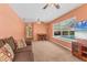 Bright living room features a sofa with views of the pool, a ceiling fan, and carpet at 4050 Rock Creek Dr, Port Charlotte, FL 33948