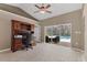Home office space with vaulted ceilings, decorative wood trim and sliding glass doors to pool area at 4050 Rock Creek Dr, Port Charlotte, FL 33948