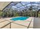 Inviting screened-in pool area surrounded by lush landscaping for ultimate privacy at 4050 Rock Creek Dr, Port Charlotte, FL 33948