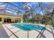 Screened in pool with attached patio and view of trees at 4050 Rock Creek Dr, Port Charlotte, FL 33948