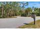 Street view of the house address on the mailbox and the long driveway at 4050 Rock Creek Dr, Port Charlotte, FL 33948