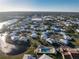 Aerial view of community featuring houses near lake, offering a picturesque residential atmosphere at 414 Circlewood Dr # H2, Venice, FL 34293
