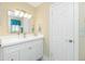 Bathroom vanity with white countertop, mirror, and modern lighting at 414 Circlewood Dr # H2, Venice, FL 34293