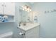 Well-lit bathroom featuring a sink, vanity, and decor at 414 Circlewood Dr # H2, Venice, FL 34293