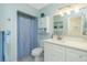 Charming bathroom featuring a vanity with drawers and storage cabinet above the toilet at 414 Circlewood Dr # H2, Venice, FL 34293