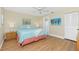 Tranquil bedroom with hardwood floors, a comfortable bed, and ample closet space at 414 Circlewood Dr # H2, Venice, FL 34293