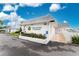 Exterior view of Circle Woods Clubhouse with well maintained landscaping and ample parking at 414 Circlewood Dr # H2, Venice, FL 34293