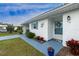 Inviting entrance featuring a charming door, blue shutters, and delightful landscaping for a welcoming appeal at 414 Circlewood Dr # H2, Venice, FL 34293