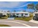 Charming single-story home featuring a well-manicured lawn and bright blue accents on the shutters at 414 Circlewood Dr # H2, Venice, FL 34293