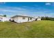 Well-maintained house exterior featuring lush green lawn and landscaped garden at 414 Circlewood Dr # H2, Venice, FL 34293