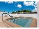 Inviting community hot tub with safety handrail at 414 Circlewood Dr # H2, Venice, FL 34293