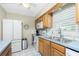 Well-equipped kitchen featuring white appliances, wood cabinets, and an airy atmosphere at 414 Circlewood Dr # H2, Venice, FL 34293
